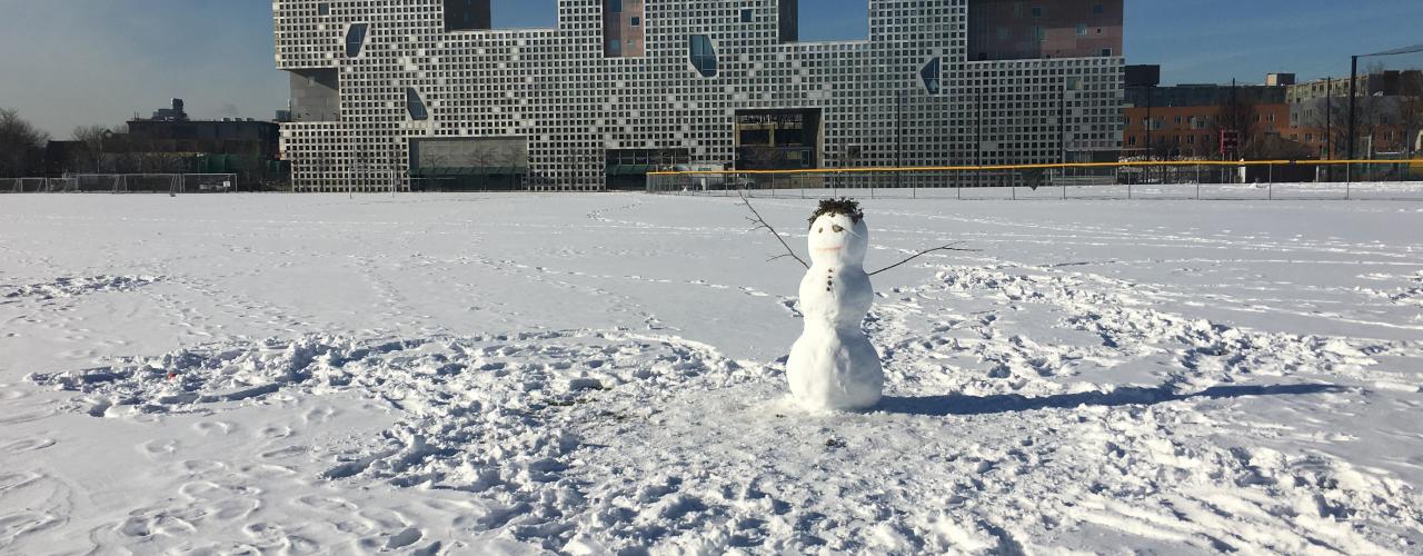 snow person in front of Simmons Hall