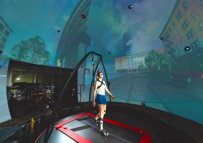 
              In the STRIVE Center, an immersive virtual reality facility overseen by the Biotechnology and Human Systems Division at Lincoln Laboratory, researchers collect data as a user tests a prototype ankle exoskeleton. 
              Photo...