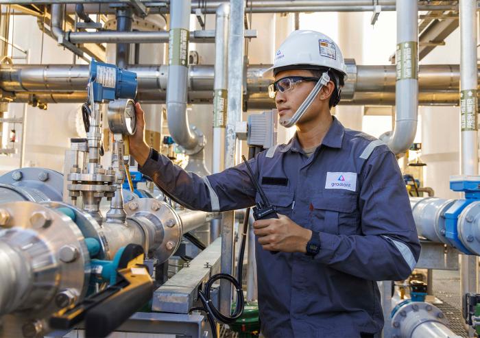 The mission of Gradiant, a firm started by MIT alumni, is to preserve water for generations to come in the face of rising global demand through innovation. Here, a worker inspects a Gradiant water treatment system.