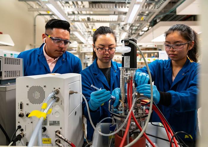 Left to right: Sebastian Esquivel, Jenna Ahn, and Crystal Chen break down whey, normally a byproduct, into components for use in animal feed. Image: Lillie Paquette / School of Engineering