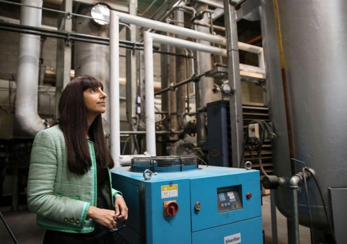Renewlogy co-founder and CEO Priyanka Bakaya inside one of the company's commercial plants, which are capable of processing ten tons of plastic each day to create about 60 barrels of fuel.Image courtesy of Renewlogy
