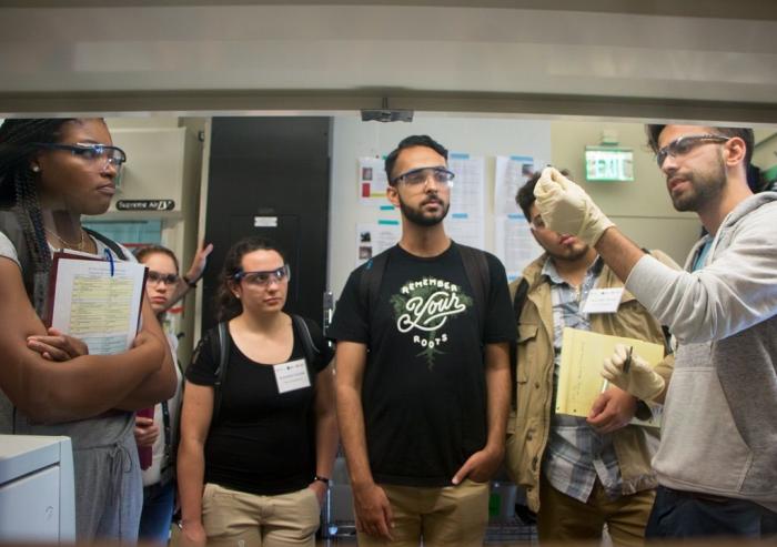 Chemical engineering postdoc Antoni Forner-Cuenca (far right) explains work in the Brushett Lab on advanced flow batteries for grid-level energy storage to 2017 MPC-CMSE Summer Scholars (l-r) Kaila Holloway, Gaetana Michelet, Alexandra Oliveira...