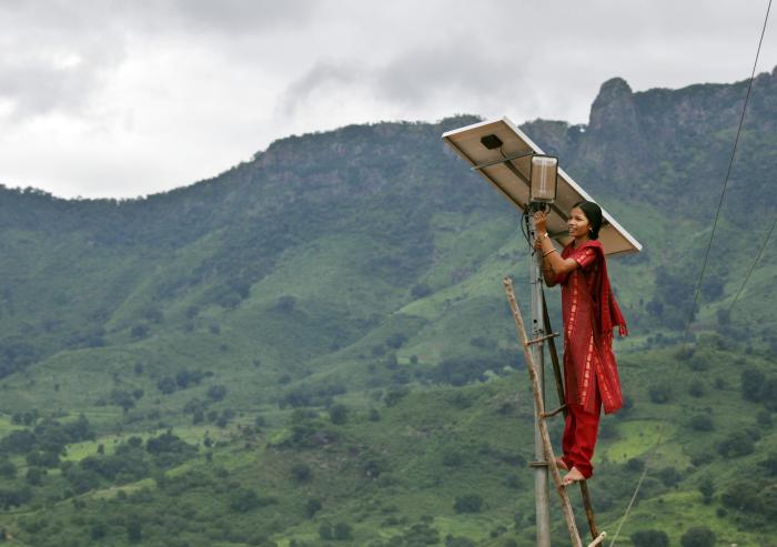 
              A solar engineer maintains the street lighting in her village of Tinginaput, India — a rural area not connected to the region’s main electrical grid. 
              Photo: Abbie Trayler-Smith/Panos Pictures
      