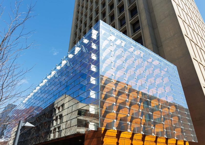 The airy exterior of the Moghadam Building, designed by AW-ARCH to complement and extend the Green Building’s Brutalist tower, is sheathed with an innovative system of wood composite overlaid with bracketed glass panels that reflect the surrounding trees and green space.