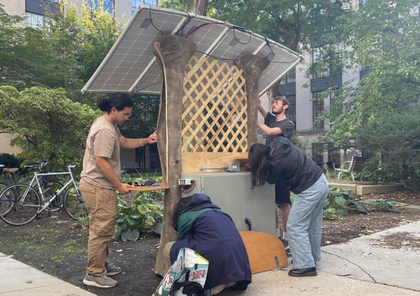 NEET scholars install their team's solar-powered charging station in an MIT campus courtyard as part of 22.03/3.0061 (Introduction to Design Thinking and Rapid Prototyping), a class offered through the NEET Climate and Sustainability Systems thread.