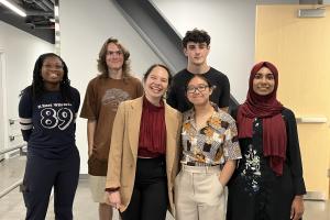 a group of students stands in a hallway