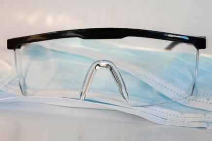 safety glasses and surgical mask on a table