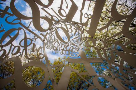 Looking into art sculpture with iron letters, numbers, and symbols