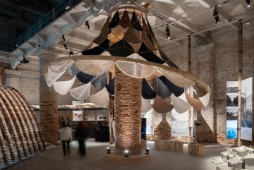 VAMO (Vegetal, Animal, Mineral, Other), is an ultra-lightweight, biodegradable, and transportable canopy designed to circle around a brick column in the Corderie of the Venice Arsenale — a historic space originally used to manufacture ropes for the city’s naval fleet.