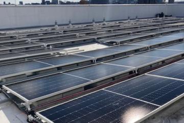 New solar panels are installed on the roof of MIT Building W46.