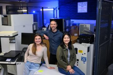 Left to right: Anastasia Dunca, Chris Rabe, and Jasmin Liu stand at the loading dock of MIT's Stata Center, where students and faculty go "crufting." Rabe facilitated an interdisciplinary working group of undergraduate and graduate students known as SERC Scholars to co-author a case study on the electronic hardware waste life cycle and climate justice.