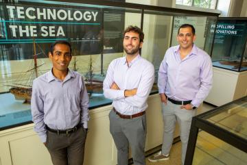 "The Nuclear Ship Safety Handbook" co-authors (left to right) Anthony Valiaveedu, Nat Edmonds, and Jose Izurieta pose in MIT's Hart Naval Gallery.