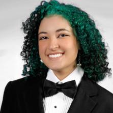 headshot of person with curly blue hair