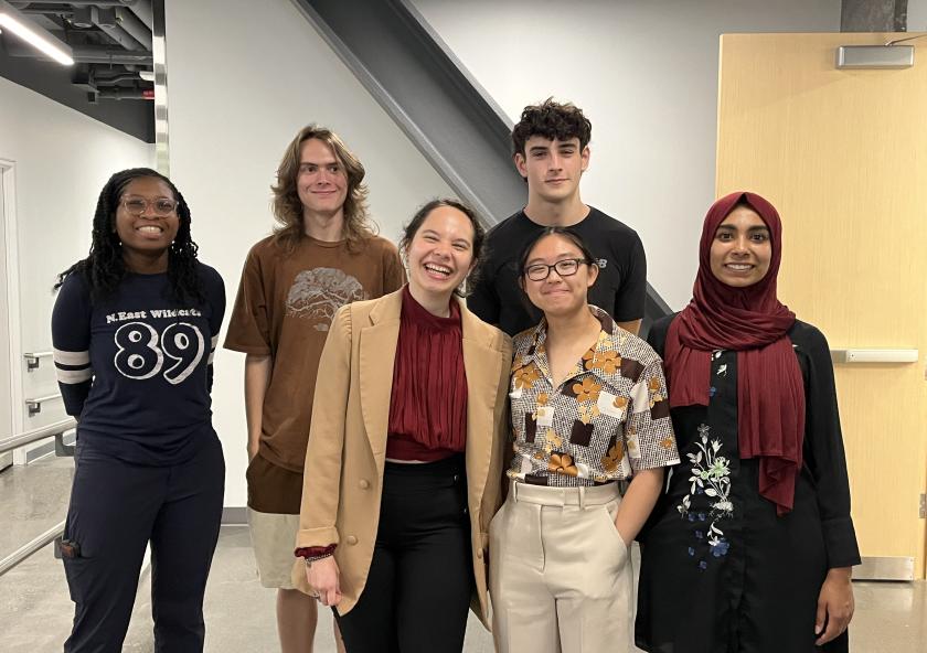 Group of 6 students standing together, smiling at the MIT Office of Sustainability