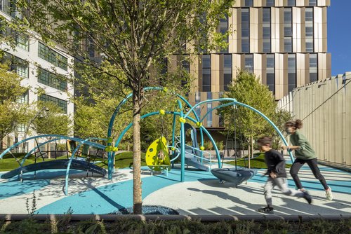 children run on a composite rooftop playground