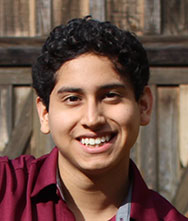 headshot of man in red shirt