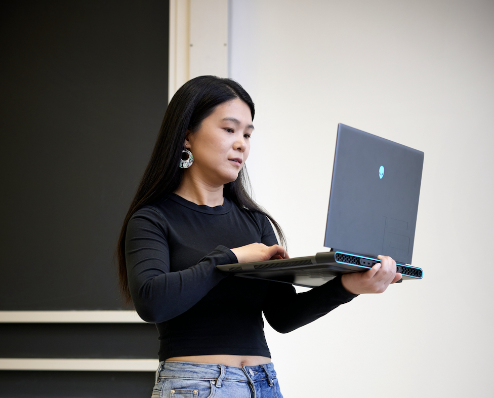 woman working on a laptop while standing
