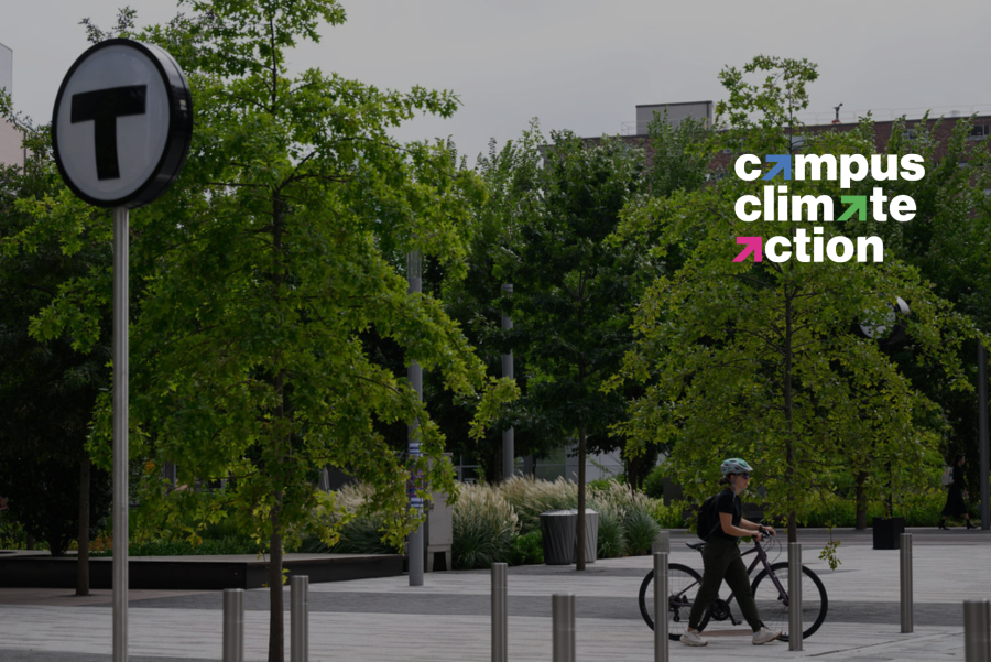 a person walks a bike in MIT open space