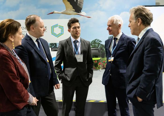 Erik Landry (center) of MIT’s Office of the Vice President for Research spoke with British Columbia’s climate minister George Heyman (far right) at the COP24 U.N. Climate Change Conference in Katowice, Poland. Joining the conversation were (lef...