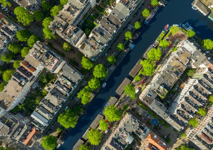 Research reveals a strong disparity in the amount of heat-mitigating tree cover within nine cities across the globe, with wealthy neighborhoods benefitting from shade the most. Amsterdam, pictured here, has a distinct pattern of less shade in lower-income areas.