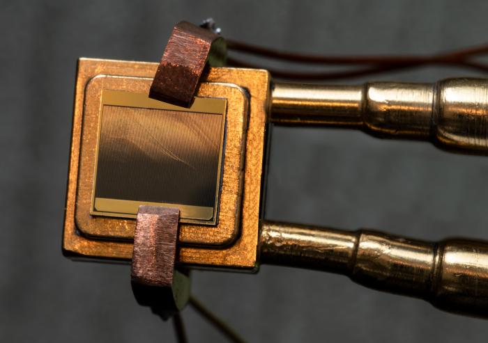 
              A thermophotovoltaic (TPV) cell (size 1 cm x 1 cm) mounted on a heat sink designed to measure the TPV cell efficiency. To measure the efficiency, the cell is exposed to an emitter and simultaneous measurements of electric power an...