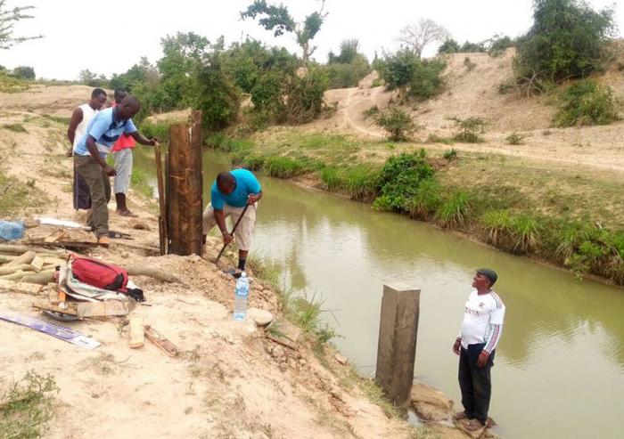 Kenya Water Resources Management Authority workers build a water quality monitoring station on the Mwache River.Photo courtesy of the Mwache Dam Project