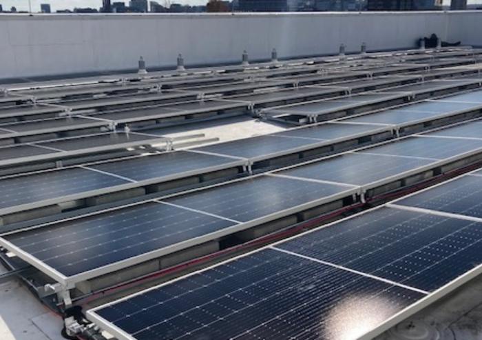 New solar panels are installed on the roof of MIT Building W46.