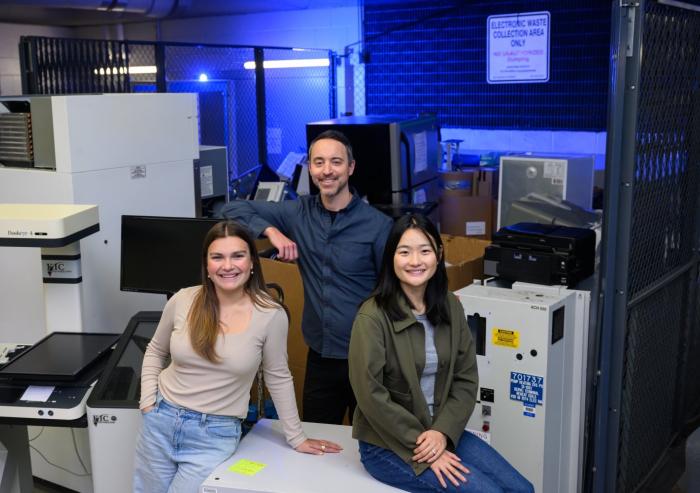 Left to right: Anastasia Dunca, Chris Rabe, and Jasmin Liu stand at the loading dock of MIT's Stata Center, where students and faculty go "crufting." Rabe facilitated an interdisciplinary working group of undergraduate and graduate students known as SERC Scholars to co-author a case study on the electronic hardware waste life cycle and climate justice.