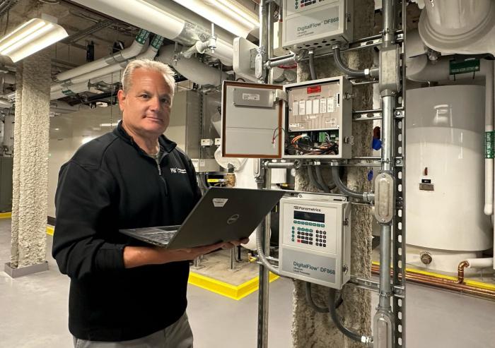 Fran Selvaggio, senior building management systems engineer in the MIT Department of Facilities, stands in the newly renovated Met Warehouse, where an innovative heat-recovery system captures heat rejected from the campus cooling system and uses electric heat pumps to generate heat for the building. 