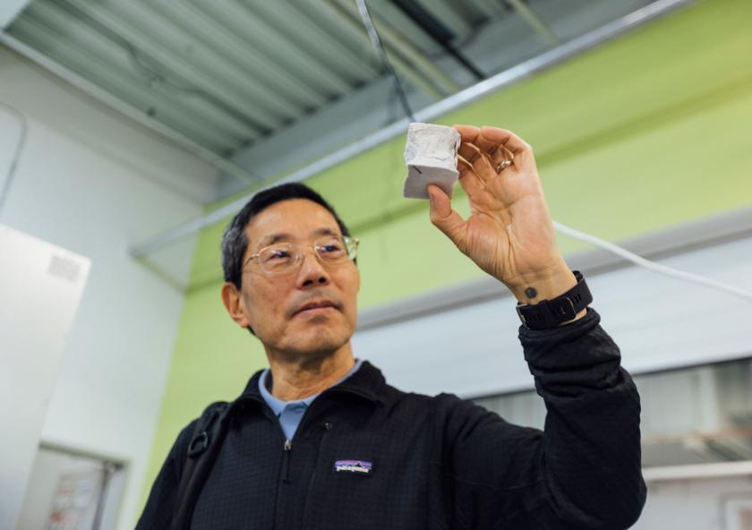 
              Professor Yet-Ming Chiang holds a mechanical test specimen of decarbonized cement.
              Credit: Bearwalk Cinema
      