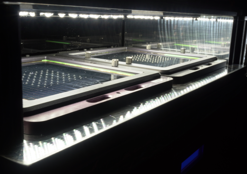 Two 150mm perovskite mini-modules are tested in an accelerated degradation system at CubicPV under 1 sun illumination on a temperature-controlled stage at 75 degrees Celsius.
Image courtesy of CubicPV.
Two 150mm perovskite mini-modules are tested in an accelerated degradation system at CubicPV under 1 sun illumination on a temperature-controlled stage at 75 degrees Celsius.
Image courtesy of CubicPV.