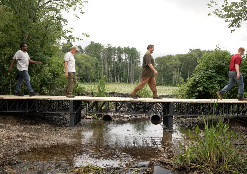 Atlas Building Composites, an MIT spinout, recently supplied the U.S. Army Corps of Engineers with American-made recycled composite trusses to construct a 40-foot bridge in a Massachusetts wetland, pictured.
