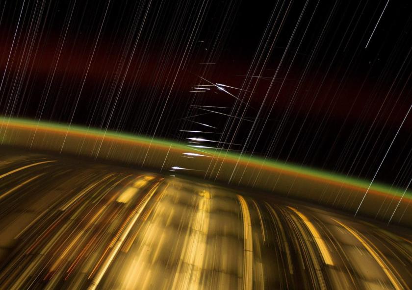 Captured by astronaut Don Pettit aboard the International Space Station (ISS), this long-exposure photograph showcases Earth's city lights, the upper atmosphere's airglow, and streaked stars. The bright flashes at the center are reflections of sunlight from SpaceX's Starlink satellites in low-Earth orbit. Captured by astronaut Don Pettit aboard the International Space Station (ISS), this long-exposure photograph showcases Earth's city lights, the upper atmosphere's airglow, and streaked stars. The bright flashes at the center are reflections of sunlight from SpaceX's Starlink satellites in low-Earth orbit.