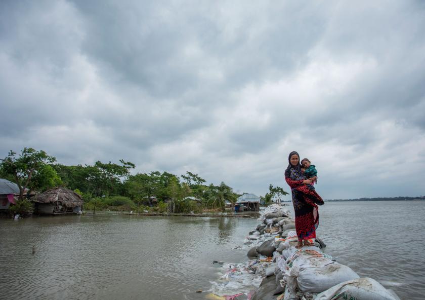 For the coastal country of Bangladesh, once-in-a-century storm tides could strike every 10 years — or more often — by the end of the century, scientists report. In this photo, a Bangladeshi woman and child walk over the top of a sandbag embankment in Khulna on May 4, 2019. For the coastal country of Bangladesh, once-in-a-century storm tides could strike every 10 years — or more often — by the end of the century, scientists report. In this photo, a Bangladeshi woman and child walk over the top of a sandbag embankment in Khulna on May 4, 2019.