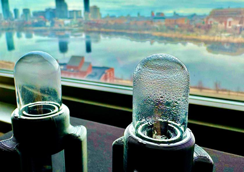 MIT engineers designed an ultrasonic system to “shake” water out of an atmospheric water harvester. The design (two prototypes shown in photo) can recover captured water in minutes rather than hours.