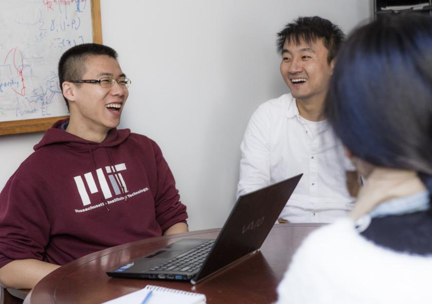 Graduate student Tianli Zhou (left) during a lab meeting. Zhou is studying how to make transportation systems more efficient, particularly through vehicle-sharing services.Photo: Alan Silfen