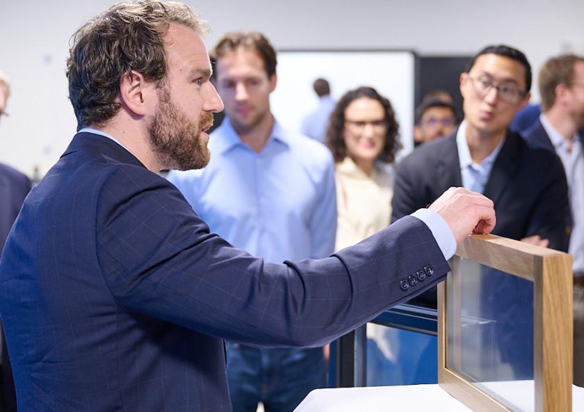 At an event marking the opening of AeroShield's new pilot manufacturing facility in Waltham, Massachusetts, Aaron Baskerville-Bridges, co-founder and vice president of operations, shows an AeroShield prototype window with the ability to cut energy losses in half. At an event marking the opening of AeroShield's new pilot manufacturing facility in Waltham, Massachusetts, Aaron Baskerville-Bridges, co-founder and vice president of operations, shows an AeroShield prototype window with the ability to cut energy losses in half.