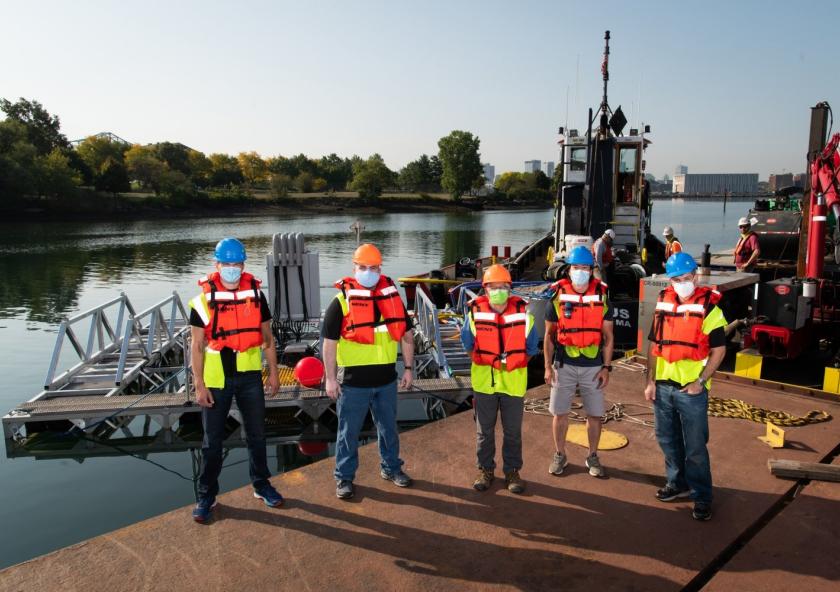 Left to right: Stephen Murray, Jason Valenzano, David Kindler, Paul Ryu, and Andrew March deploy their 8 m × 8 m sonar array test bed, held together by a metal frame, in Boston Harbor for sea tests. Left to right: Stephen Murray, Jason Valenzano, David Kindler, Paul Ryu, and Andrew March deploy their 8 m × 8 m sonar array test bed, held together by a metal frame, in Boston Harbor for sea tests.