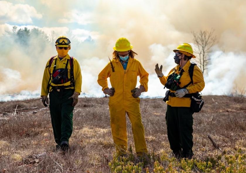 
              Kathleen Theoharides (center) oversees the Commonwealth’s six environmental, natural resource, and energy regulatory agencies. In this role, the secretary joined MassWildlife for a prescribed burn on April 8 at the Birch Hil...
