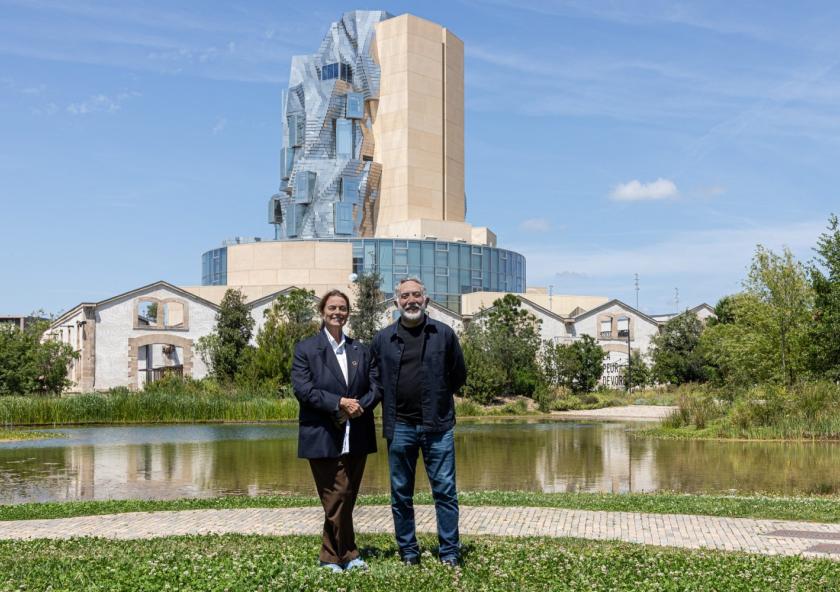 Maja Hoffmann (left), founder and president of the LUMA Foundation, and Hashim Sarkis, dean of the MIT School of Architecture and Planning, at LUMA Arles in the Parc des Ateliers in France. This 27-acre interdisciplinary campus is an experimental site of exhibitions, artists’ residencies, research laboratories, and educational programs that includes The Tower, a multipurpose space designed by Frank Gehry, seen here amid 19th-century factory buildings.