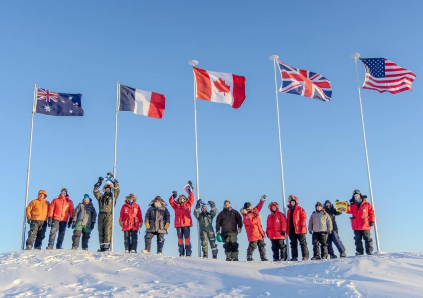Scientists participating in Operation Ice Camp 2024 display flags representing their countries. 