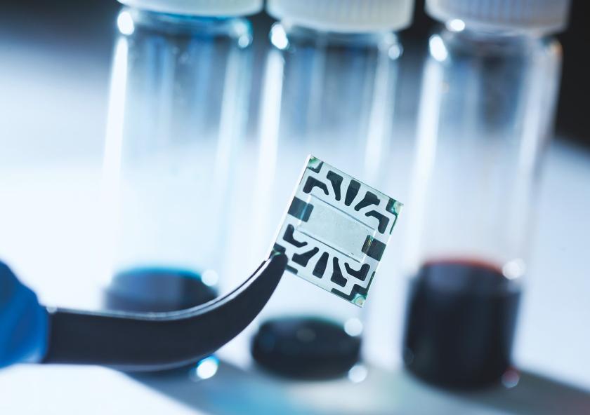 A new flexible graphene solar cell developed at MIT is seen in the transparent region at the center of this sample. Around its edges are metal contacts on which probes can be attached during tests of device performance.Photo: Stuart Darsch A new flexible graphene solar cell developed at MIT is seen in the transparent region at the center of this sample. Around its edges are metal contacts on which probes can be attached during tests of device performance.Photo: Stuart Darsch