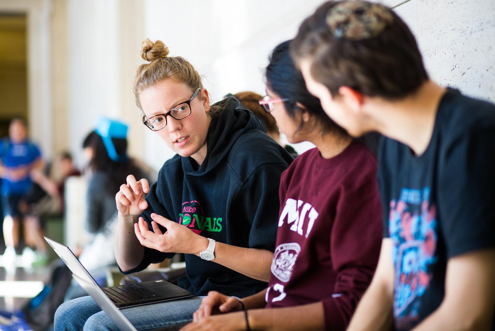 a group of students talks with in the Infinite Corridor