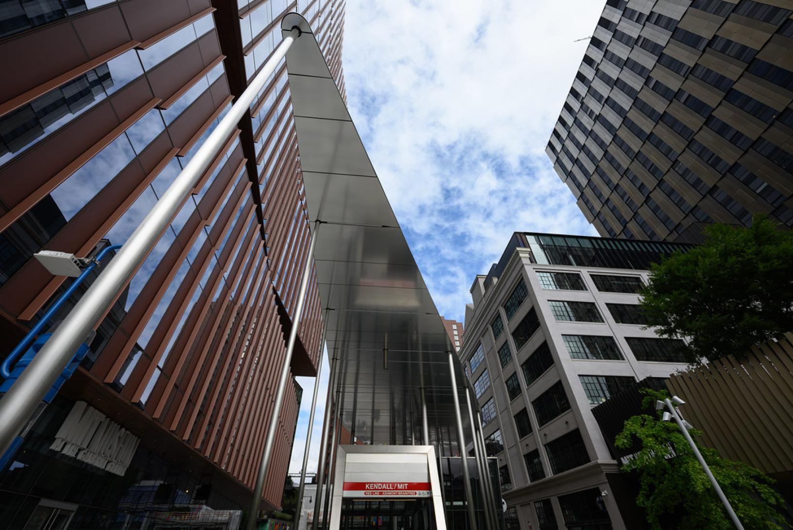 entrance to a subway station amidst high rise buildings
