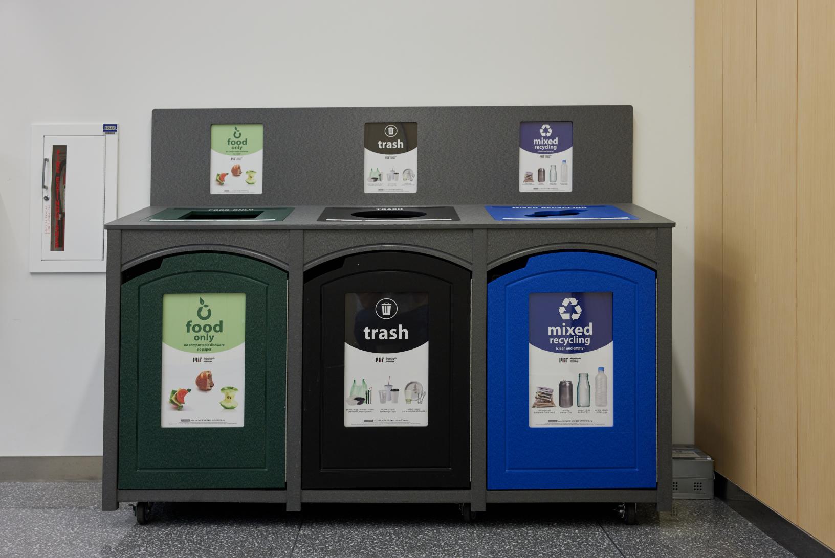 a three bin station with food waste, trash, and recycling bins
