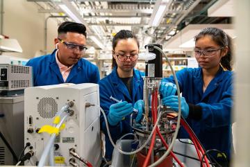 Left to right: Sebastian Esquivel, Jenna Ahn, and Crystal Chen break down whey, normally a byproduct, into components for use in animal feed. Image: Lillie Paquette / School of Engineering
