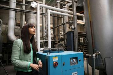 Renewlogy co-founder and CEO Priyanka Bakaya inside one of the company's commercial plants, which are capable of processing ten tons of plastic each day to create about 60 barrels of fuel.Image courtesy of Renewlogy