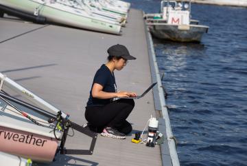 
              Charlene Xia, pictured at the MIT Sailing Pavilion, tests her microbiome monitoring system in the Charles River.
              Photo: John Freidah, MIT Mechanical Engineering
      