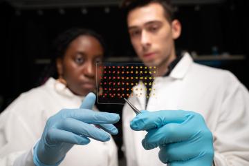 MIT graduate students Eunice Aissi, left, and Alexander Siemenn, have developed a technique that automatically analyzes visual features in printed samples (pictured) to quickly determine key properties of new and promising semiconducting materials.