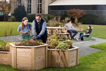 
              Norman Magnuson (second from left) worked closely with students in the development and maintenance of The Hive sustainability garden. 
              Photo: M. Scott Brauer 
      